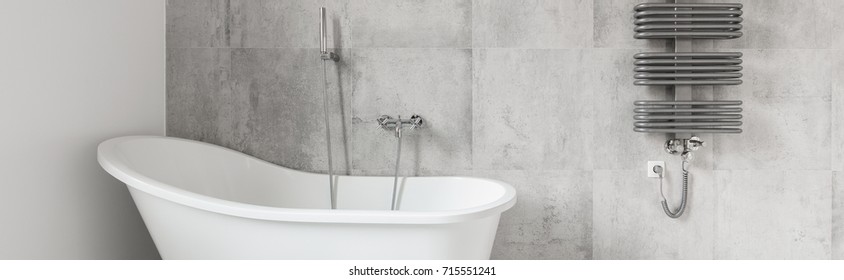 Concrete Design Bathroom With Stylish Bathtub And Grey Radiator