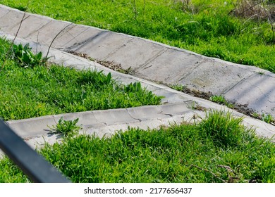 Concrete Drain With Grass In The Garden. Drain Channel. Flowing. Meet. Outside. Path. Rain. Stadium. Stream. Tunnel. Way. Channel. Flood. Surface. Basin. Empty