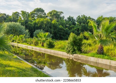 Concrete drainage channel filled with water in the subtropics after rains - Shutterstock ID 2238665853