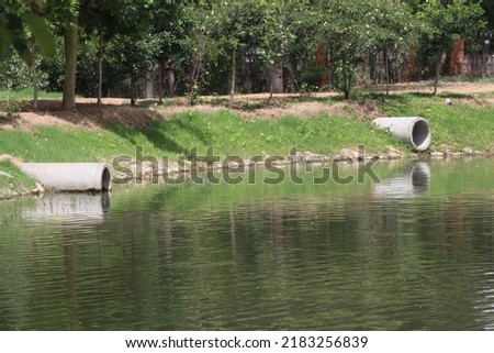 Concrete drainage pipes are installed above the surface of a lake to prevent the excessive filling of rainwater in the lake