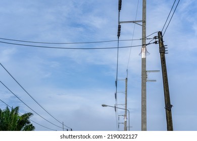 Concrete Electric Pole With Voltage Wire In Background Blue Sky, The Utility Infrastructure For Residential Building