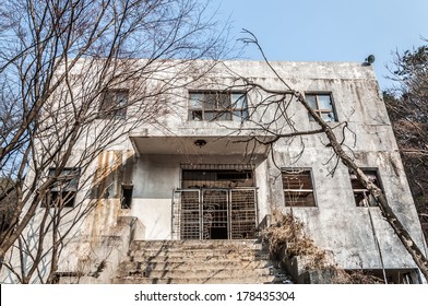 The Concrete Exterior Of An Old Abandoned Mental Hospital.