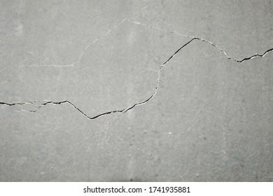 The concrete floor is cracked with time. - Shutterstock ID 1741935881