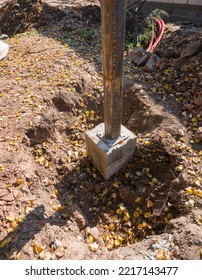 Concrete Foundation For Metal Post To Hold Up Awning Of A Small Residential Building. Construction Site Image Taken On A Sunny Autumn Day