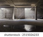 Concrete garage with two columns and water puddle