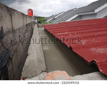 Concrete gutters corner viewed with red sandblasted spandex.