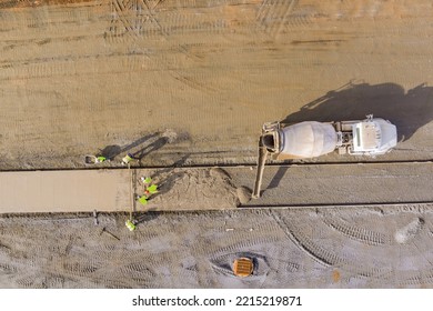 An Concrete Mix Truck Pouring Concrete At Construction Site During Workers Pouring Of Cement For Sidewalk