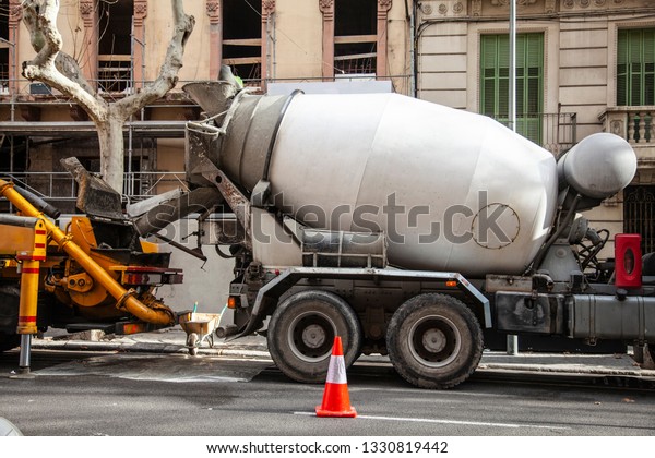 Concrete mixer pours concrete\
into the pump on the construction of a monolithic building.\
Transportation of Cement and other Construction\
Materials.