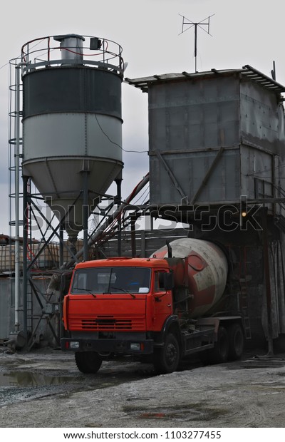 The concrete mixer truck is charged with concrete\
in the factory