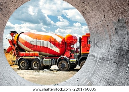 Concrete mixer truck in front of a concrete batching plant, cement factory. Loading concrete mixer truck. Close-up. Delivery of concrete to the construction site.