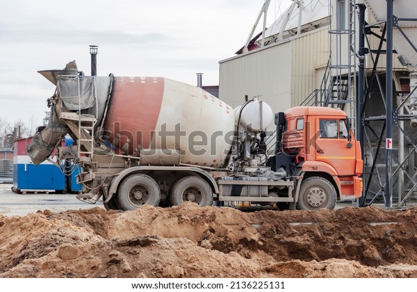 Concrete mixer truck loads concrete\
at the factory. Transportation of concrete to the construction\
site. Construction equipment for the delivery of\
concrete