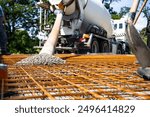 Concrete Mixer Truck Pouring Concrete onto Rebar Framework