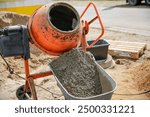 Concrete in an orange mixer on construction site