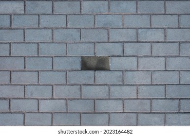 Concrete Or Paved Gray Paving Slabs Or Stone Flooring Top View. One Tile Is Missing In The Middle. Reinforced Concrete Products For Road Construction.