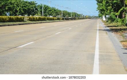 Concrete pavement road with longitudinal joint, construction joint,traffic lane line and traffic island.Empty concrete road.