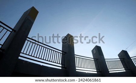 concrete pillar and fence with clear sky background, copy space