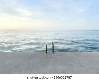 concrete platform on calm sea background. concrete beach with metal handrails. nature pool. horizon. waterline background. seawater surface. minimalistic background - Powered by Shutterstock