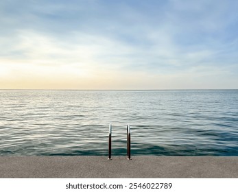 concrete platform on calm sea background. concrete beach with metal handrails. nature pool. horizon. waterline background. seawater surface. minimalistic background - Powered by Shutterstock