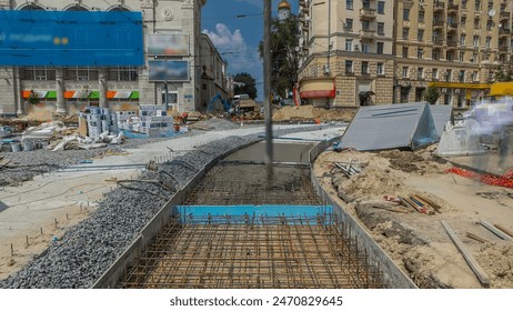 Concrete pouring works to reinforcement for road construction with many workers in uniform and concrete pump machine timelapse. Reconstruction of tram tracks - Powered by Shutterstock