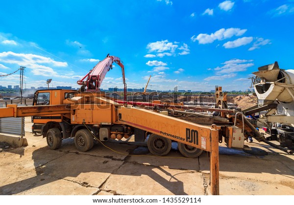 concrete pump building under construction. Concrete\
pump on high rise building under construction site with crane.\
Cement mixer truck with pump is preparing to put concrete on\
foundation. Moscow\
2019