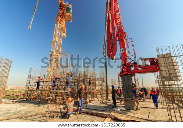 concrete pump building under construction. Concrete\
pump on high rise building under construction site with crane.\
Cement mixer truck with pump is preparing to put concrete on\
foundation. Moscow\
2019