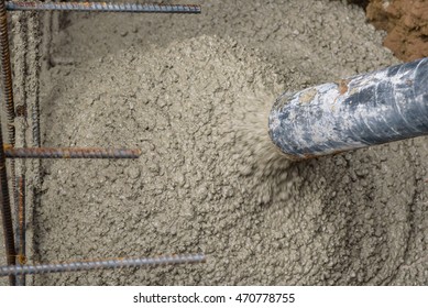 Concrete pumping hose filling foundation hole
