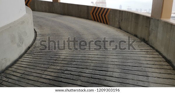 Concrete ramp going up/down to a\
parking lot.\
backgrounds/textures