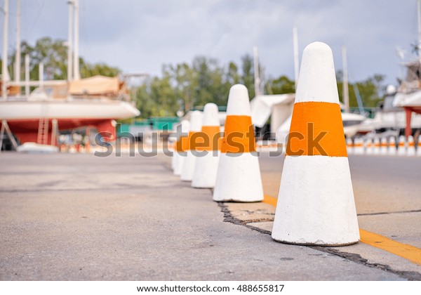 Concrete road cones on dock\
road.
