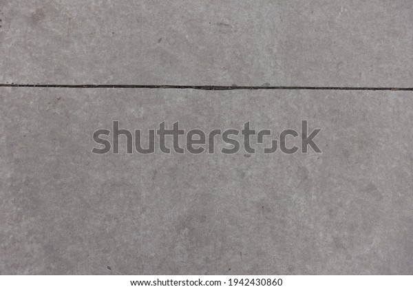 Concrete
slab with joint dividing it in two unequal
parts
