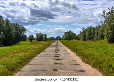 Concrete Slab Road Along In Rural Area.