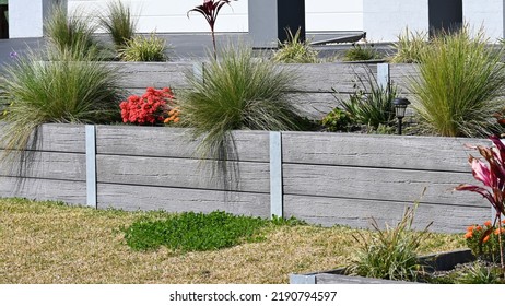 Concrete sleeper retaining wall designed to look like wood - Shutterstock ID 2190794597