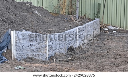 Concrete sleeper retaining wall during construction