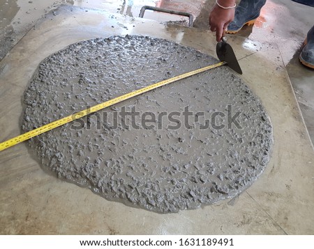 The concrete slump flow test checking in lab to determine work-ability of fresh concrete