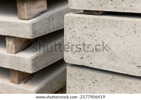 Concrete stacked building blocks. Building material used for housing or real estate construction, close-up shot. Due to the making process concrete is an unsustainable and not eco-friendly resource