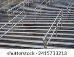 Concrete Staircase with Metal Handrails and Textured Steps