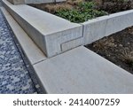 concrete staircase is new and smooth. seating stairs for students and people in the park. lawn benches and beds with perennials in combination with building element, auditorium, school yard, classroom