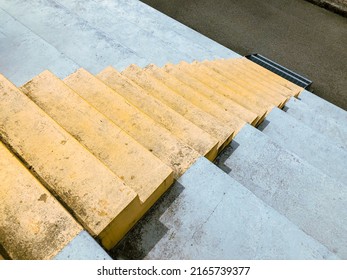 Concrete staircase. Yellow colored minimalist stairs in perspective. Top down view from stairs. 