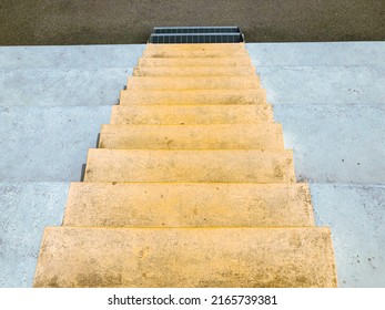 Concrete staircase. Yellow colored minimalist stairs in perspective. Top down view from stairs. 
