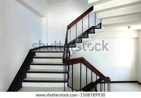 concrete stairs are wooden handrails. ladder in the building. Empty modern building stairway