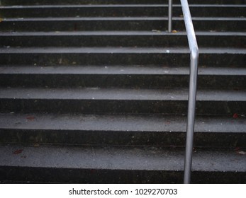 Concrete Stairway With Metal Banister Covered With Ice. 