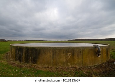 Concrete Storage Tank For Manure Filled To The Brim. 