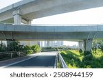 Concrete structure and asphalt road space under the overpass in the city