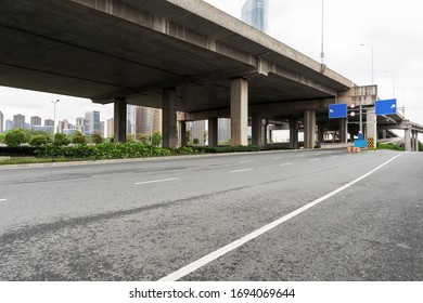 Concrete structure and asphalt road space under the overpass in the city - Shutterstock ID 1694069644