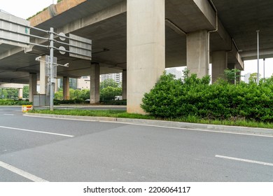 Concrete structure and asphalt road space under the overpass in the city - Shutterstock ID 2206064117
