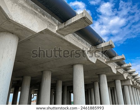 Concrete structure supporting the highway overpass. Low angle close up shot during day time