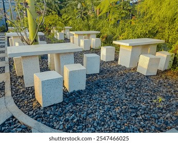 Concrete table and chairs geometric shapes outdoor. Plaster cast table and chair in the garden
 - Powered by Shutterstock