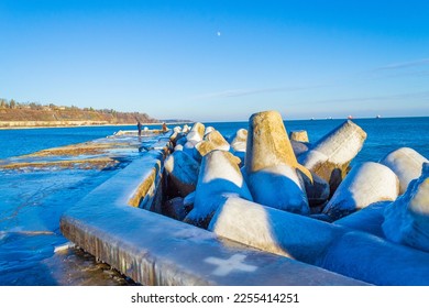 Concrete tetrapod blocks covered with ice on nice winter day at a breakwater on Black Sea coast,Varna beach ,Bulgaria