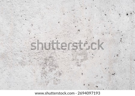 Concrete texture creating an abstract gray wall background, showing rough detail and imperfections from aging cement