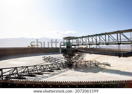 Concrete thickiner for mining plant. It is a process where a slurry or solid-liquid mixture is separated to a dense slurry containing most of the solids and an overflow of essentially clear water.