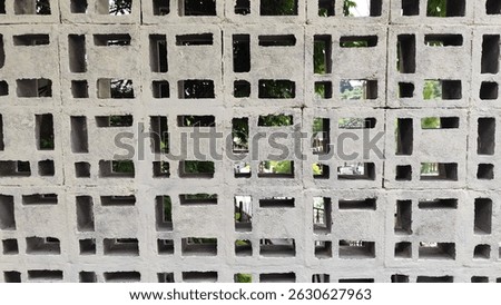 Concrete ventilation wall with geometric pattern. Hollow block design for natural airflow and light in urban architecture.